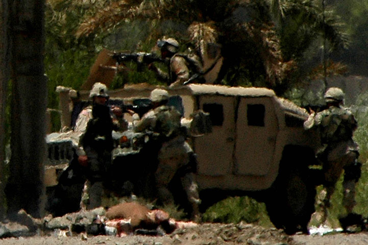 American soldiers return fire as their convoy is ambushed. Iraq.