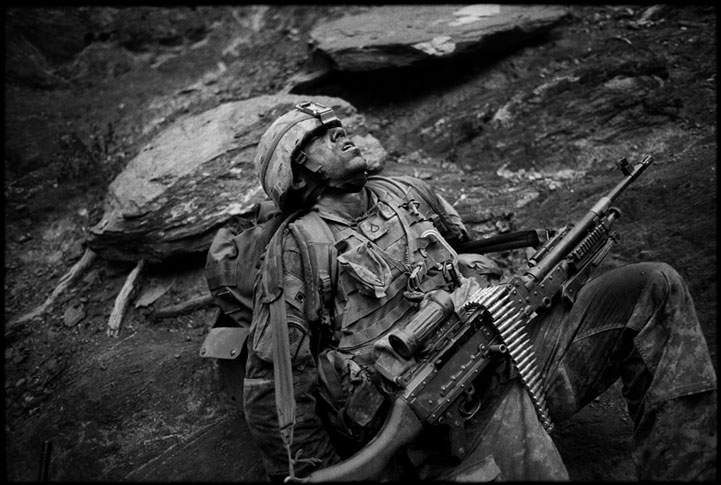 American soldier collapses in exhaustion. Korengal valley, Afghanistan 2007.